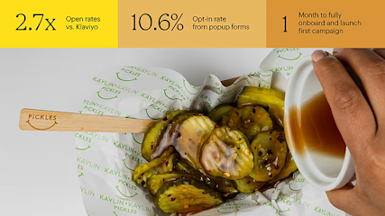 Pickles on branded paper with wooden spoon, next to coffee cup, with business metrics displayed above